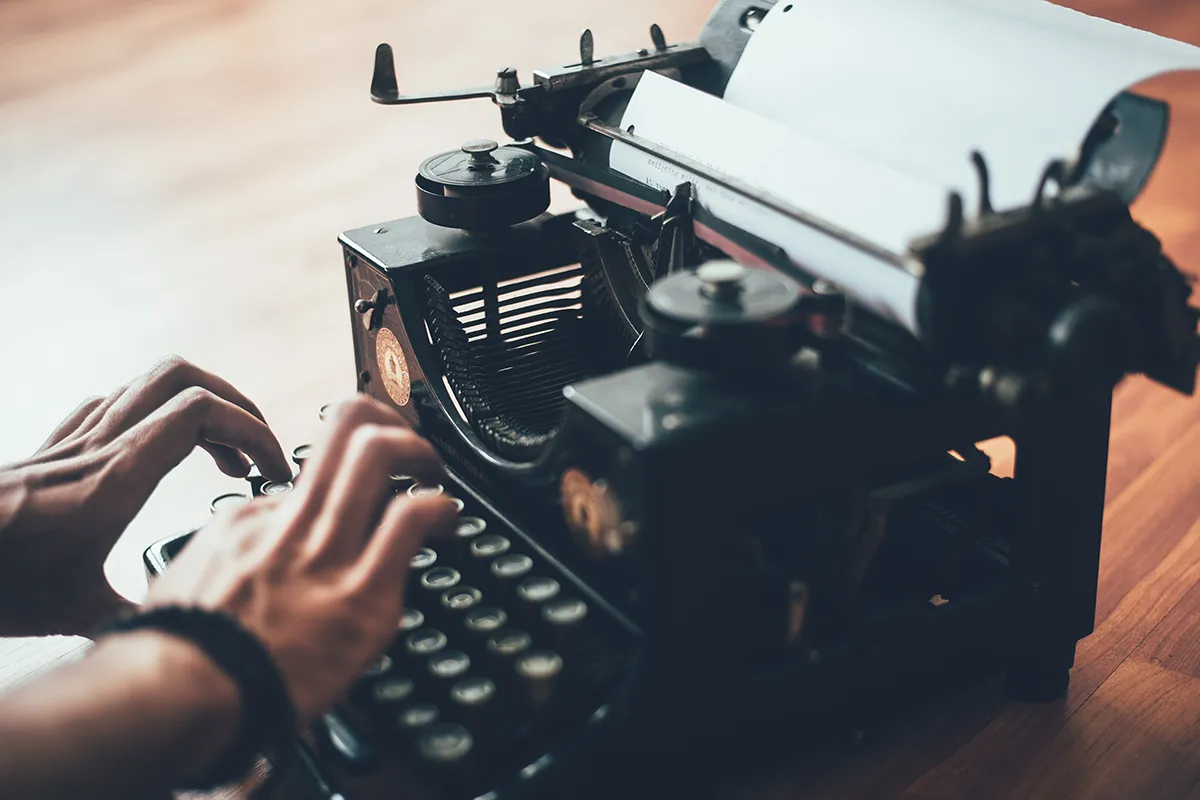 Photo of a person using a typewriter